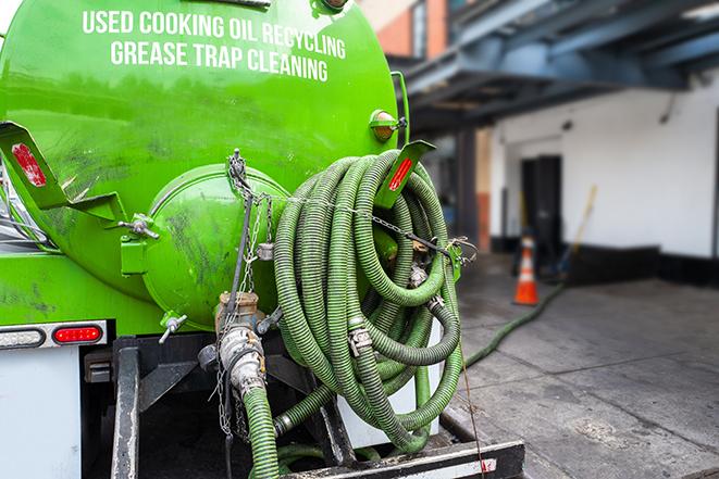 a grease trap pumping truck at a restaurant in Ashburn, VA